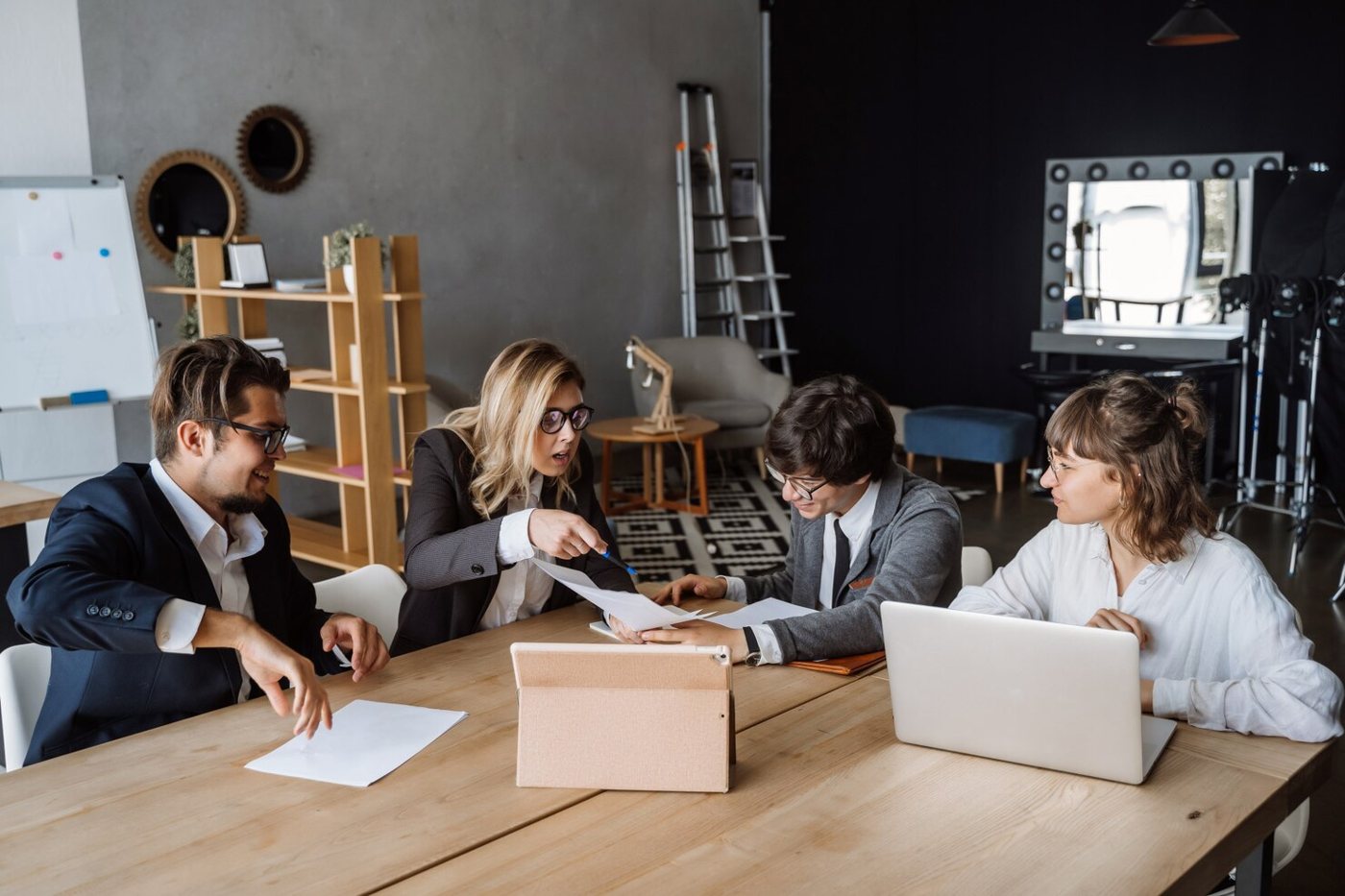 Colleagues reviewing documents at a meeting table