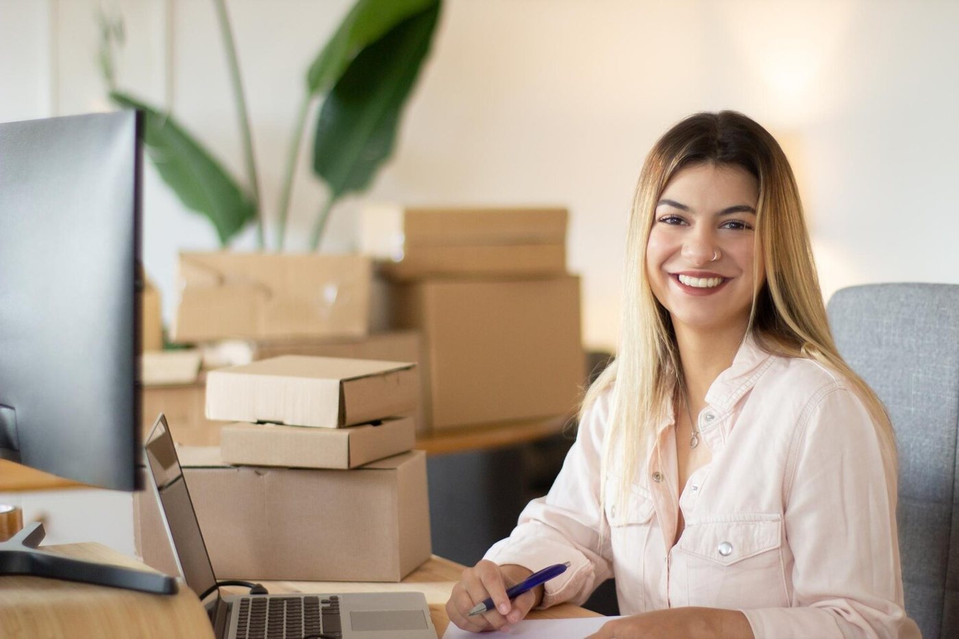Customer service representative at a desk with parcels
